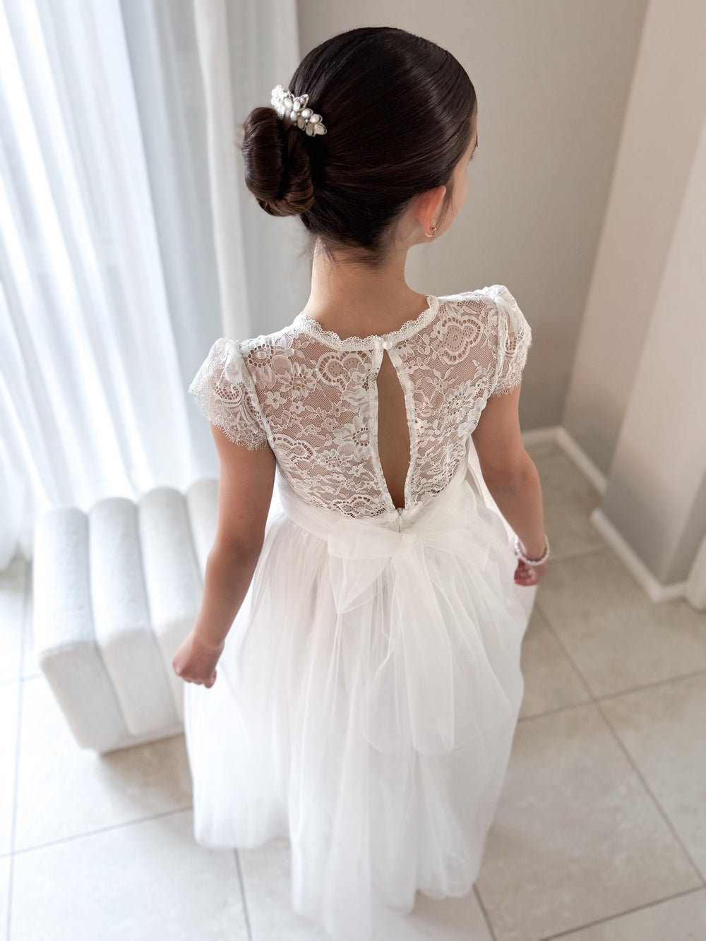 Girl wearing Abby Grace White Lace Dress for First Communion or flower girl