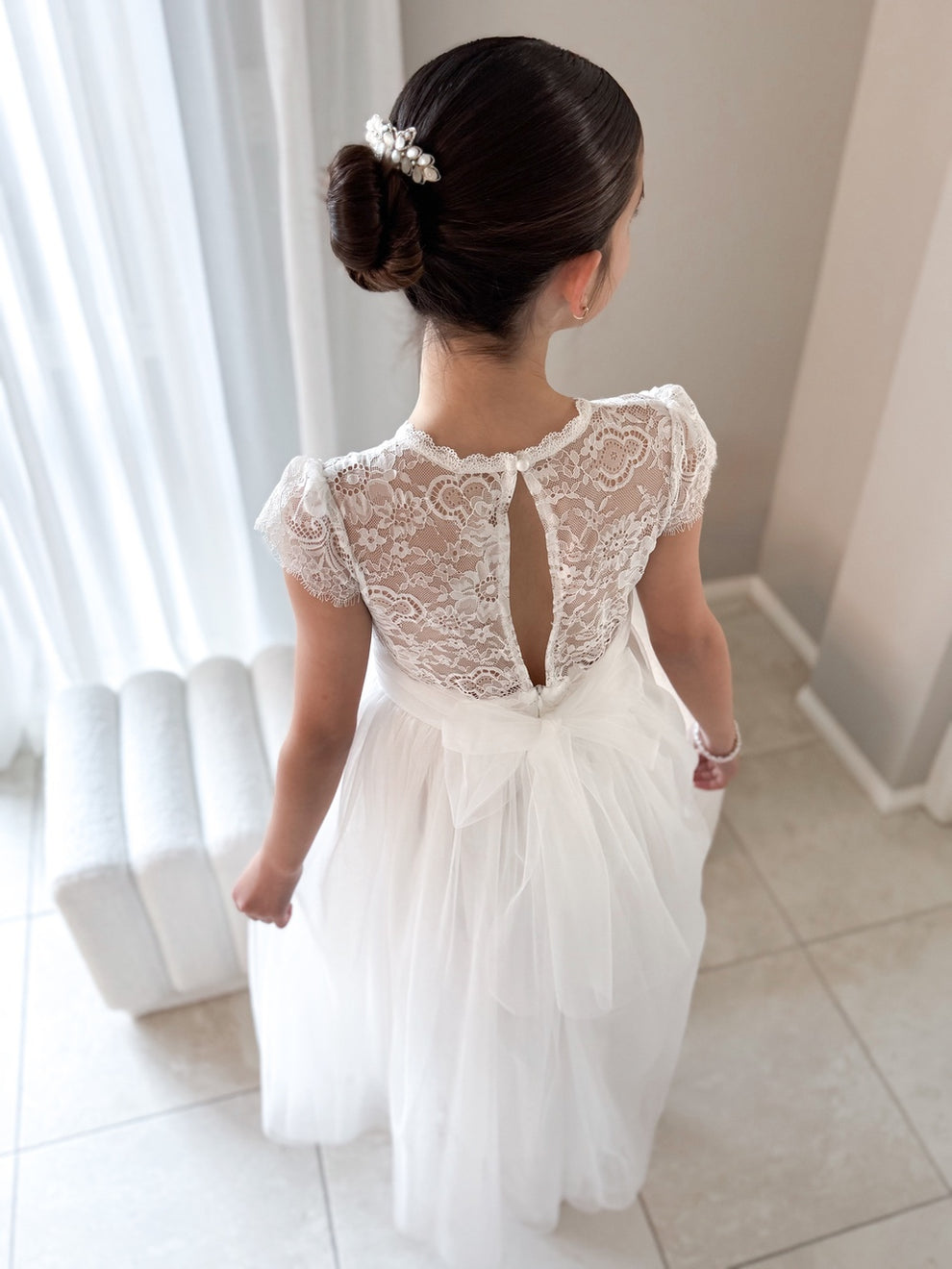 Girl wearing Abby Grace White Lace Dress for First Communion or flower girl