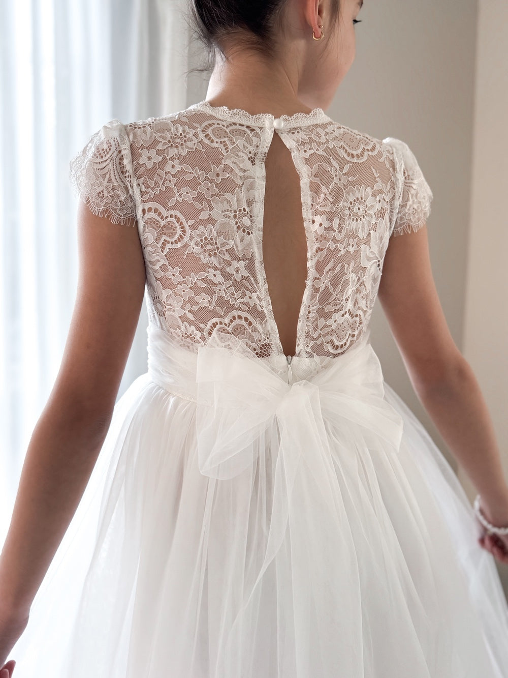 Back view of Abby Grace White Lace Dress – button-up open back with tulle bow