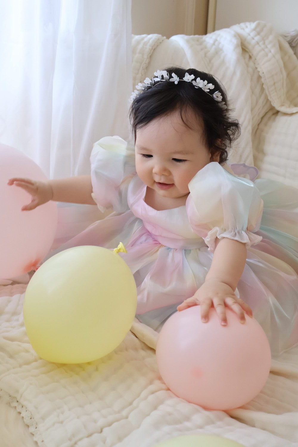 Anastasia Baby Rainbow RomperClose-up of rainbow organza fabric shimmering on baby birthday romper with cotton lining