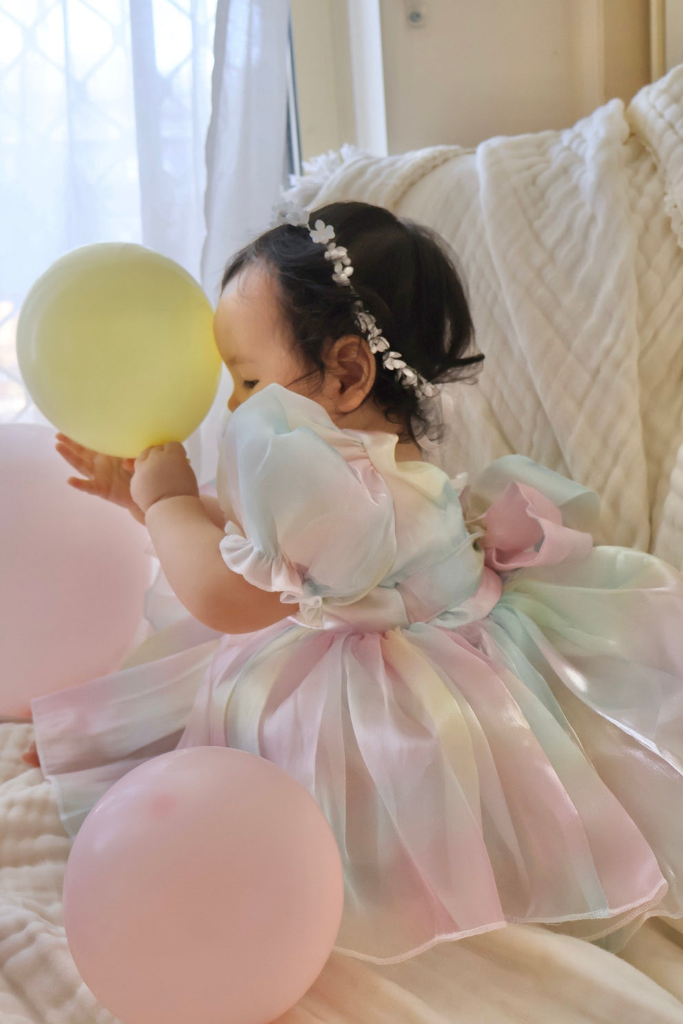 Back view of baby romper showing comfy fit and snap-button nappy cover for easy changes