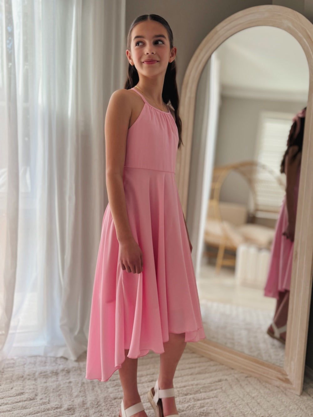Side view of pink hi-low chiffon dress with layered movement