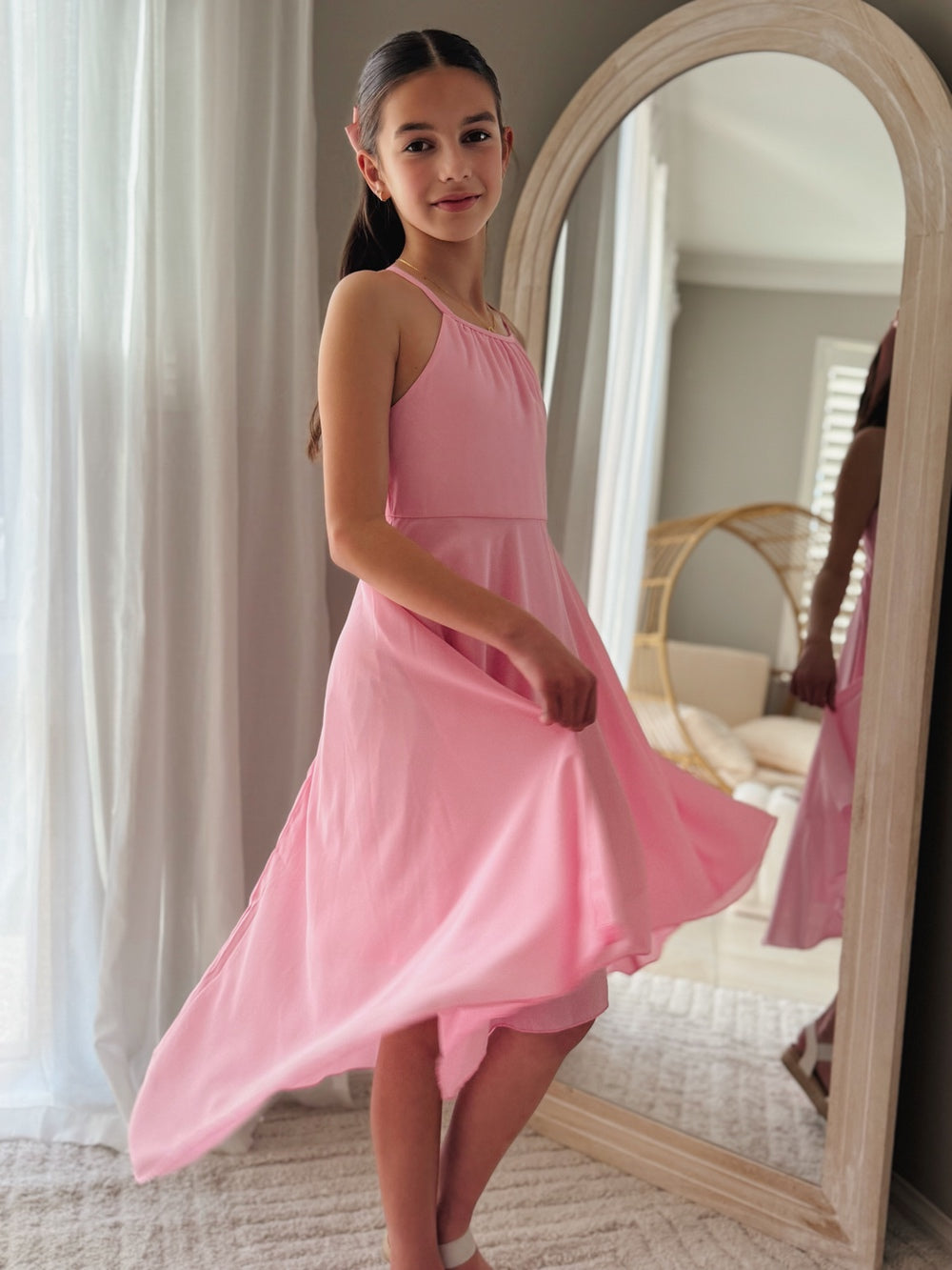Movement shot of pink chiffon dress with high-low hem