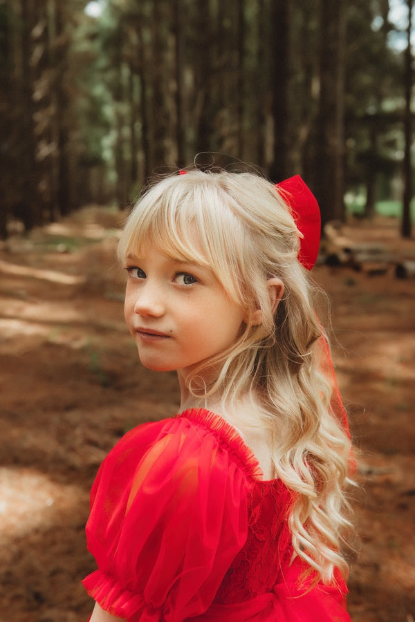 little girls tulle xmas dress with puff sleeves and red bow