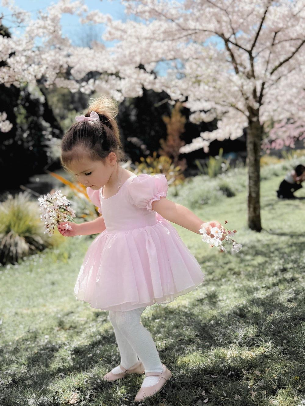 Arabella Pink Girls Baby Dress - Baby DressesBaby girl wearing Arabella pink dress romper with puff sleeves and shimmer skirt overlay