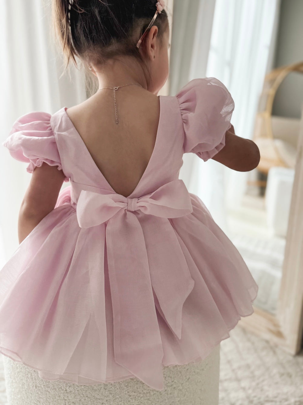 Arabella girls pink dress with large bow tied at the lower back