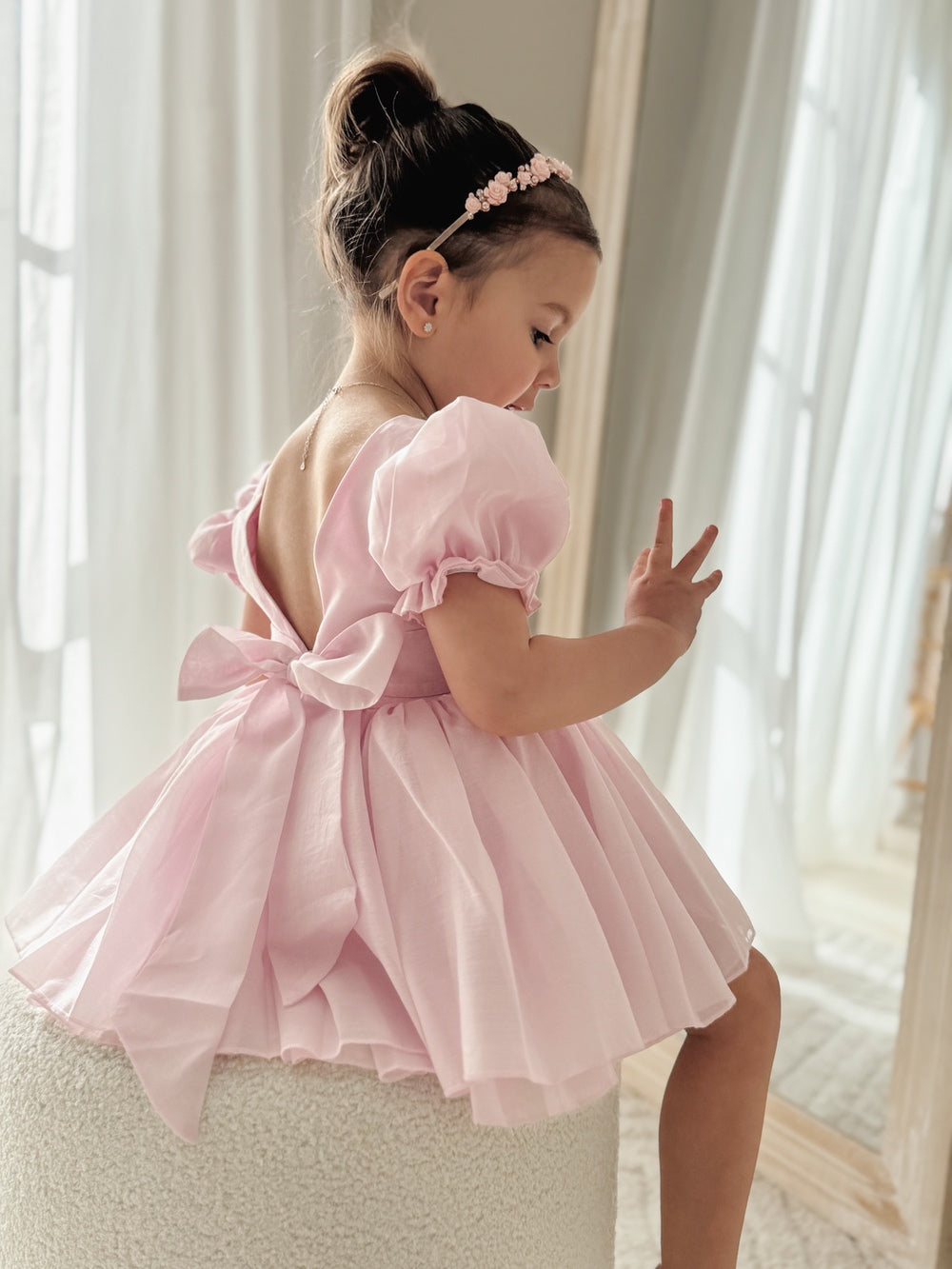 Soft pink girls dress with dramatic bow detail at the back