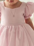 Front view of girls pink puff sleeve dress with flared skirt