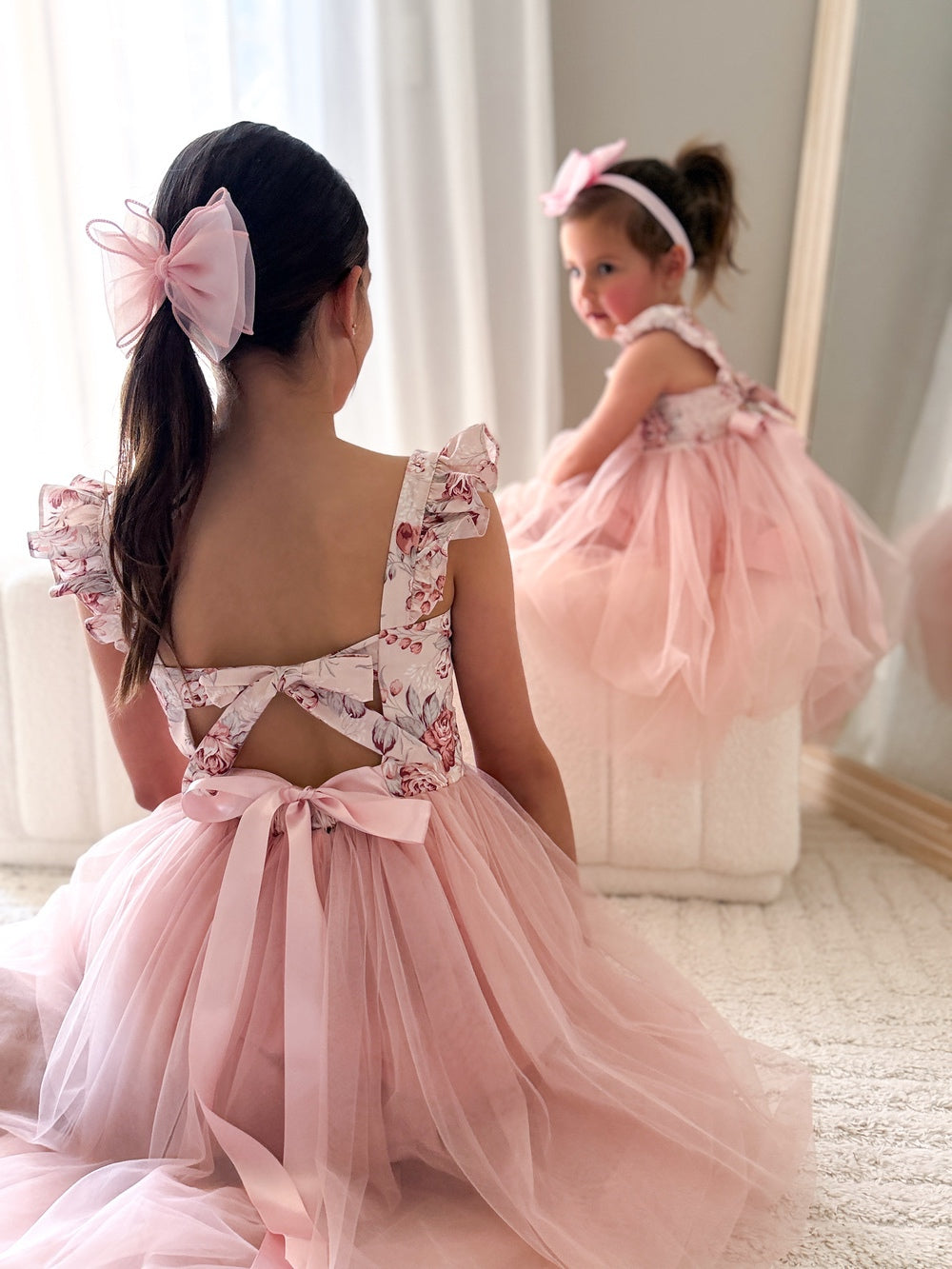 Back view showing elegant tie-up bow and soft flowing tulle skirt
