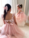 Back view showing elegant tie-up bow and soft flowing tulle skirt