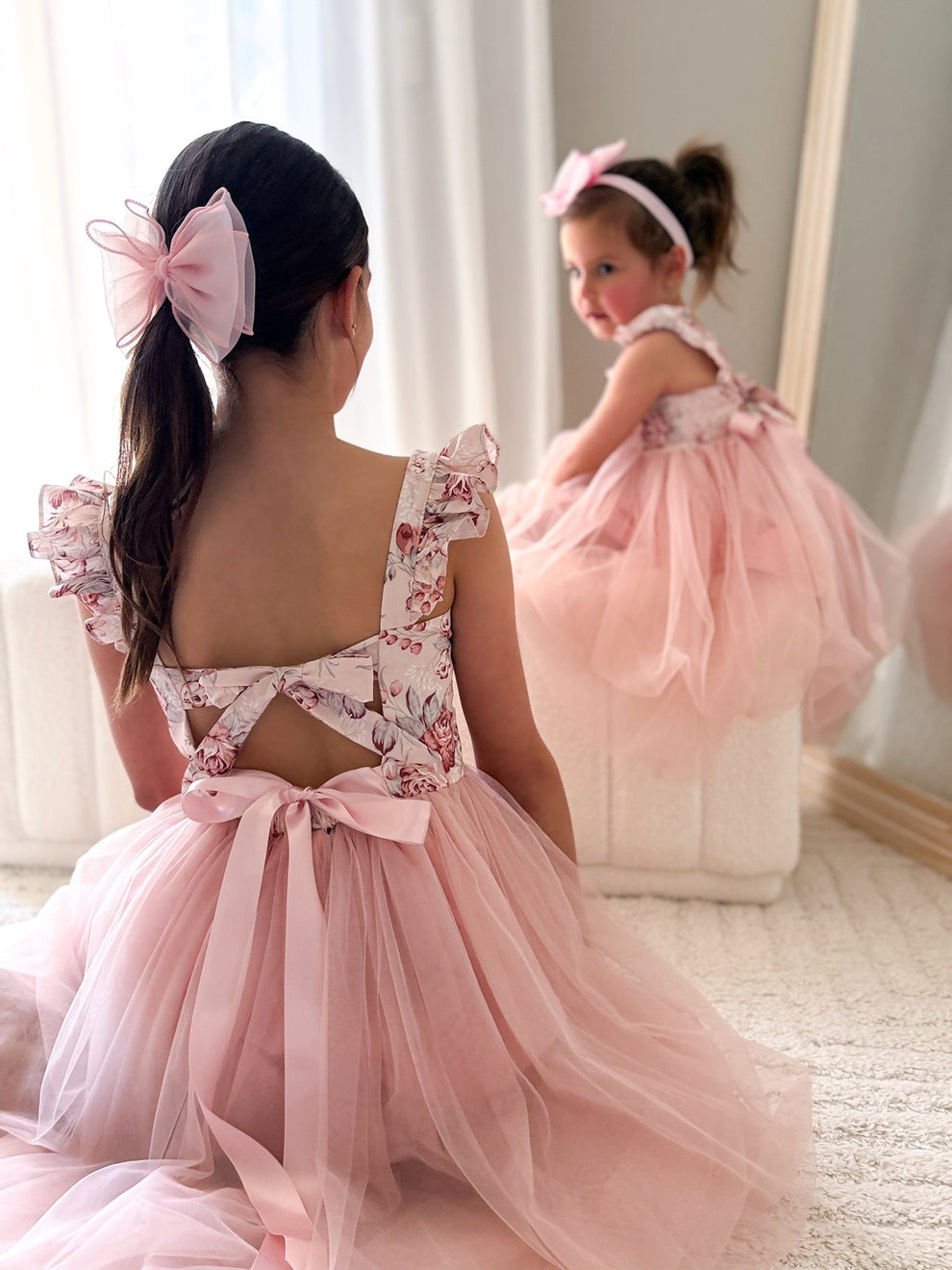 Back view showing elegant tie-up bow and soft flowing tulle skirt