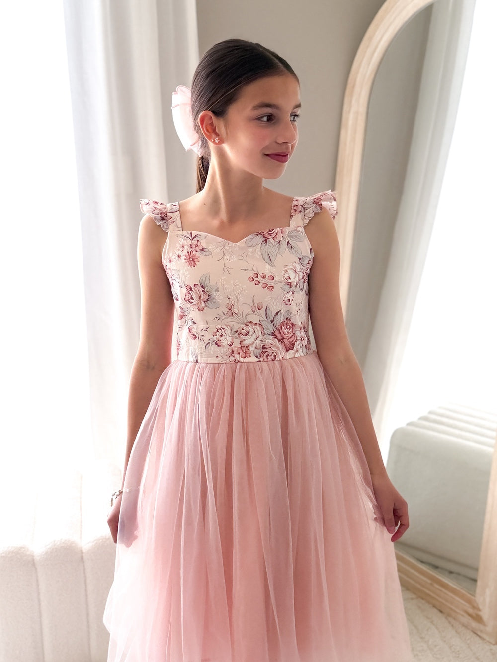 Front view of nectar pink girls tulle dress with ruffle shoulders and satin sash