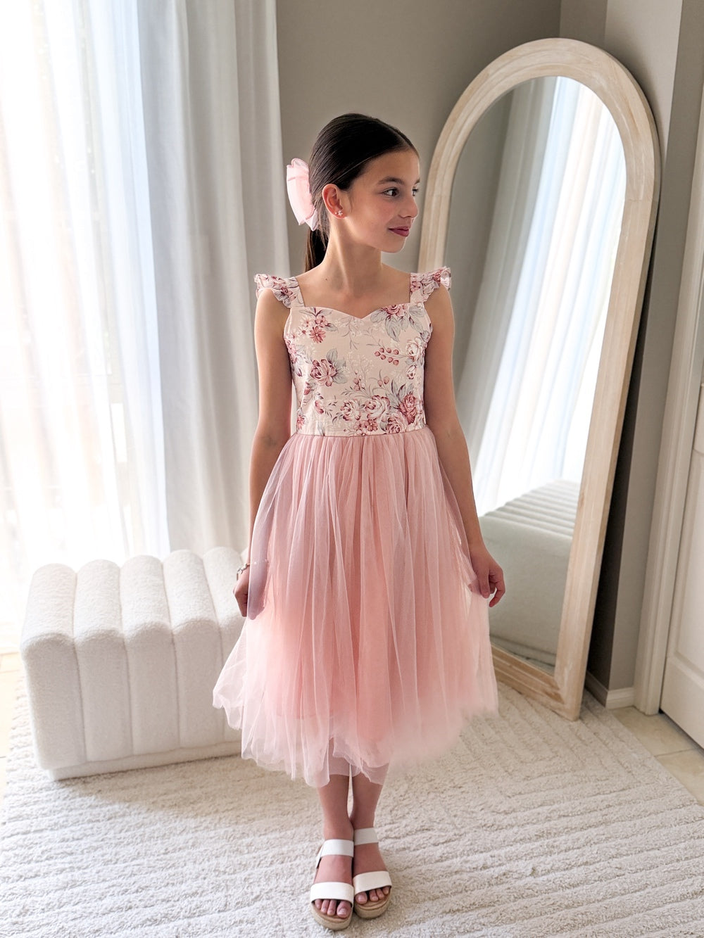 Below-knee pink girls flower girl dress with satin sash tied at the back