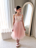 Below-knee pink girls flower girl dress with satin sash tied at the back