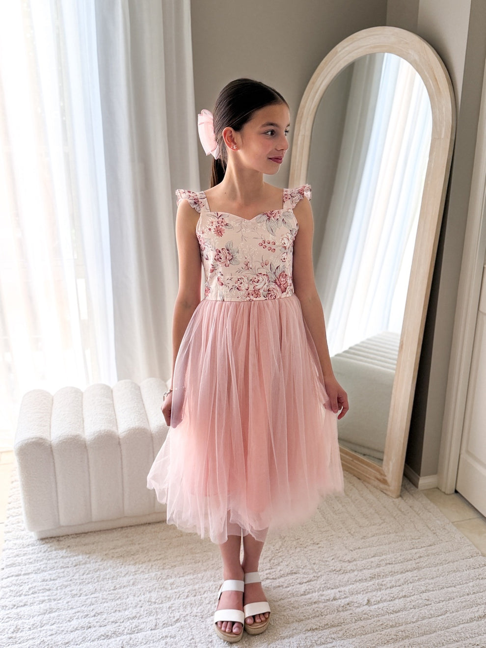 Below-knee pink girls flower girl dress with satin sash tied at the back