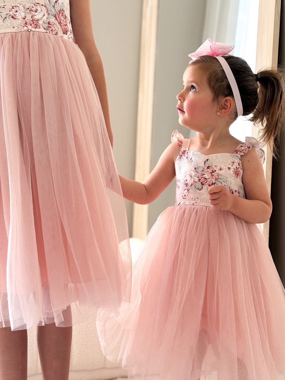 Child in Audrey Rose Nectar Dress smiling during family photo shoot