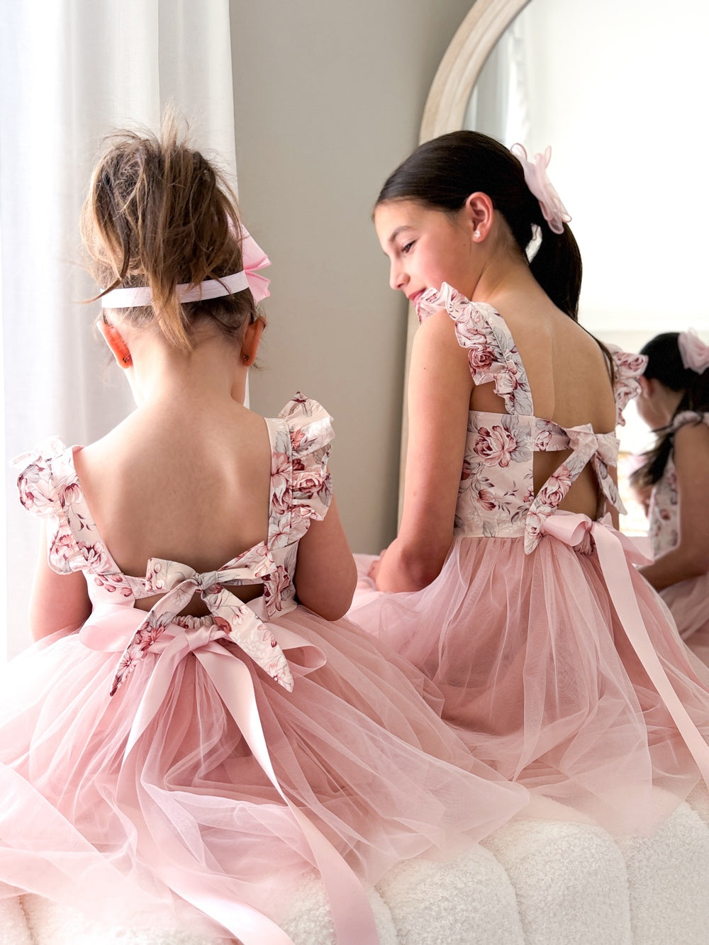 Detail shot of ruffle sleeves and tie-up back on Audrey Rose Girls Dress