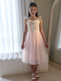 Girl wearing Audrey Rose Light Pink Tulle Dress with floral bodice and bow back