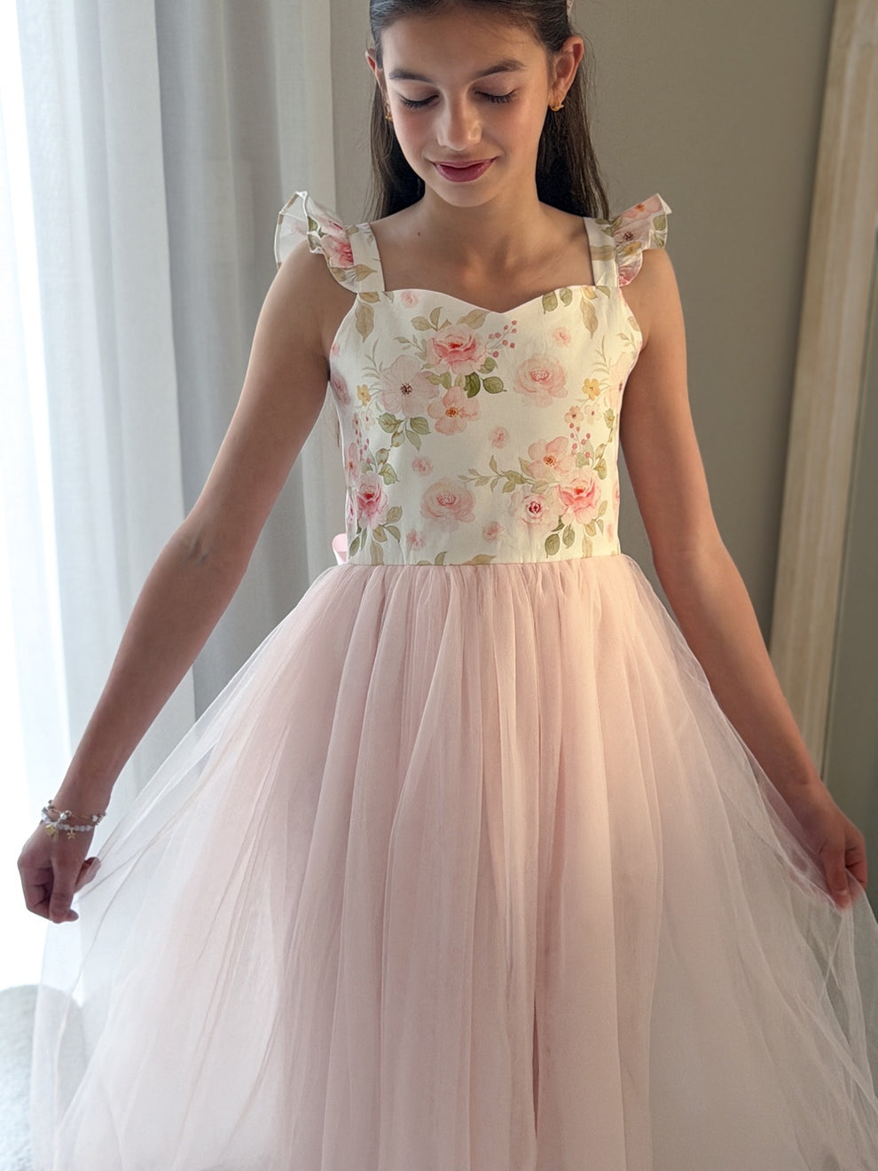 Detail of floral bodice and satin sash on Audrey Rose Light Pink girls dress