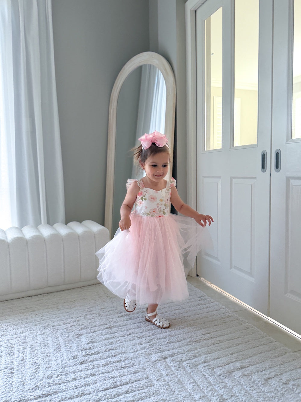 Elegant light pink tulle dress with floral print bodice styled for wedding photos