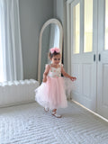Elegant light pink tulle dress with floral print bodice styled for wedding photos