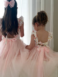 Elegant light pink tulle dress with floral print bodice styled for wedding photos