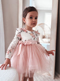 Front view of girls dusty pink floral long sleeve dress for special occasions