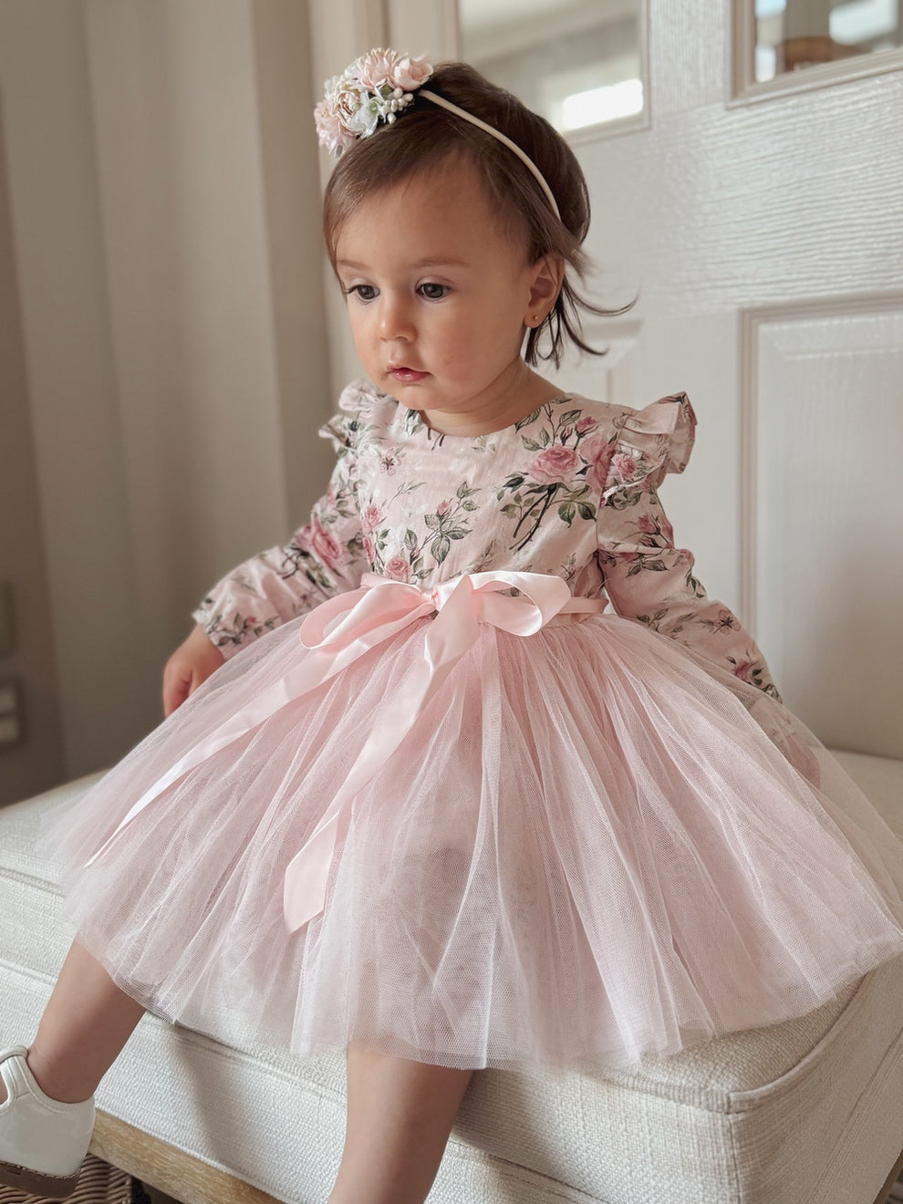 Toddler wearing Audrey Rose girls long sleeved party dress with ruffle shoulders and floral tulle skirt