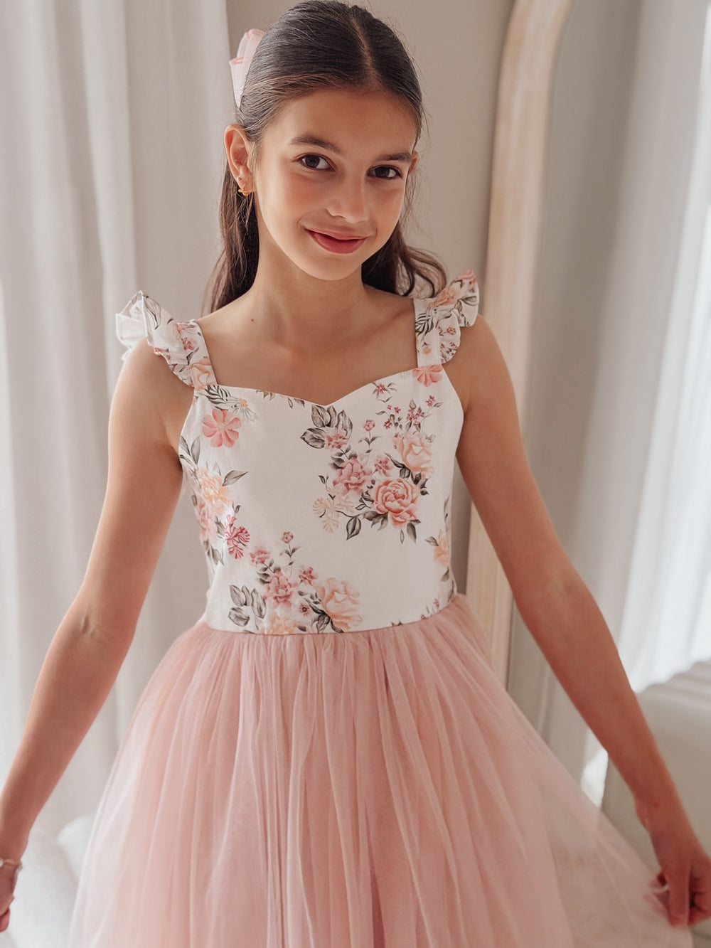 Detail shot of soft tulle skirt and floral lace bodice in dusty pink tones