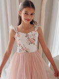 Detail shot of soft tulle skirt and floral lace bodice in dusty pink tones