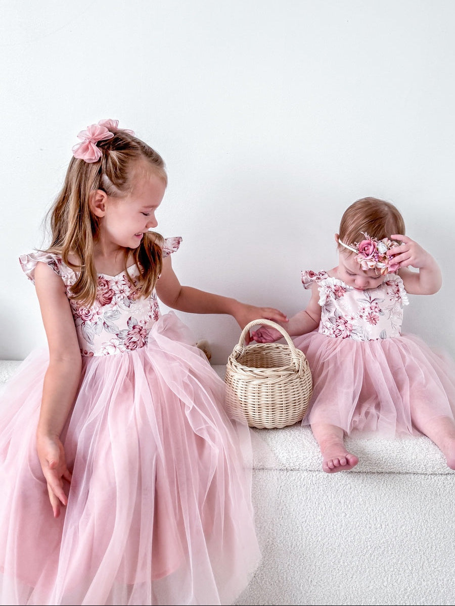 Girls in pink floral party dresses