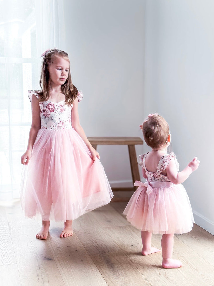 Girls in matching pink floral Party dresses 