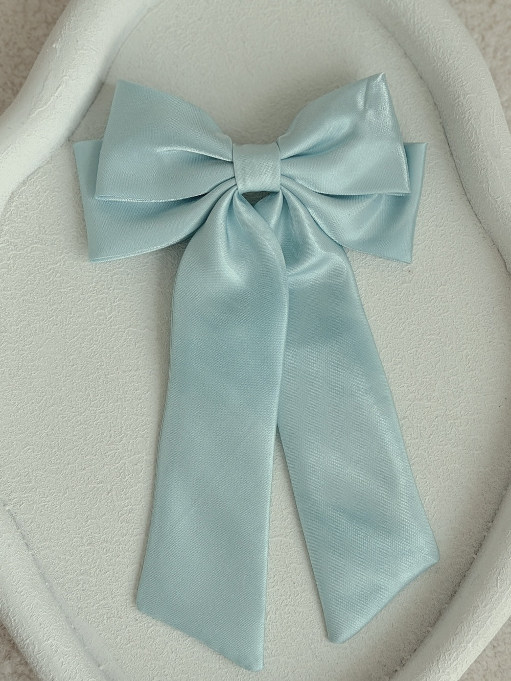 Statement blue satin bow with long tails