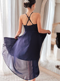 Girl twirling in navy blue hi-low dress with flowy layers