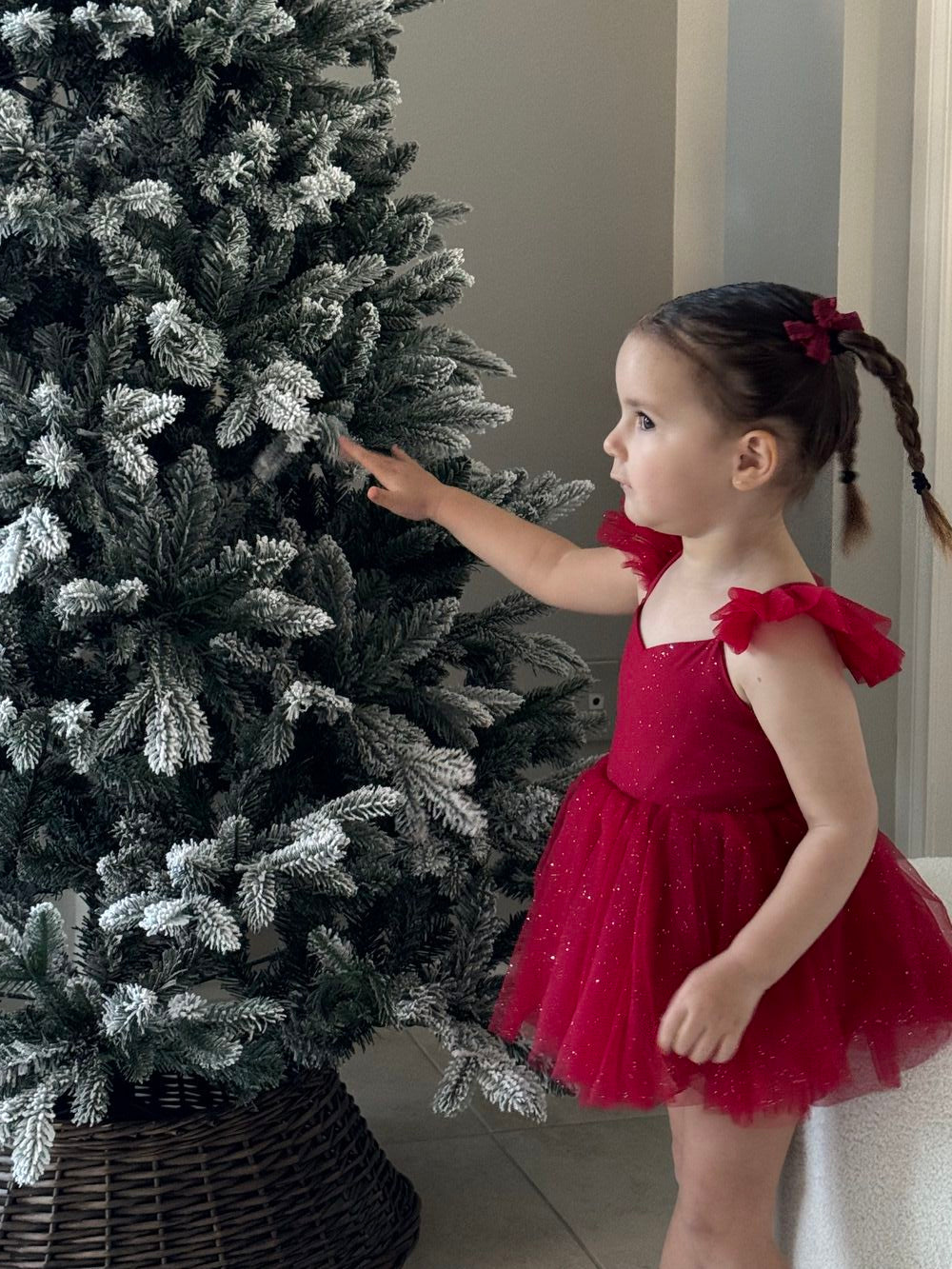 Belle Red Sparkle Christmas Baby Dress - Baby RompersBaby girl in red sparkle romper captured mid-play at Christmas