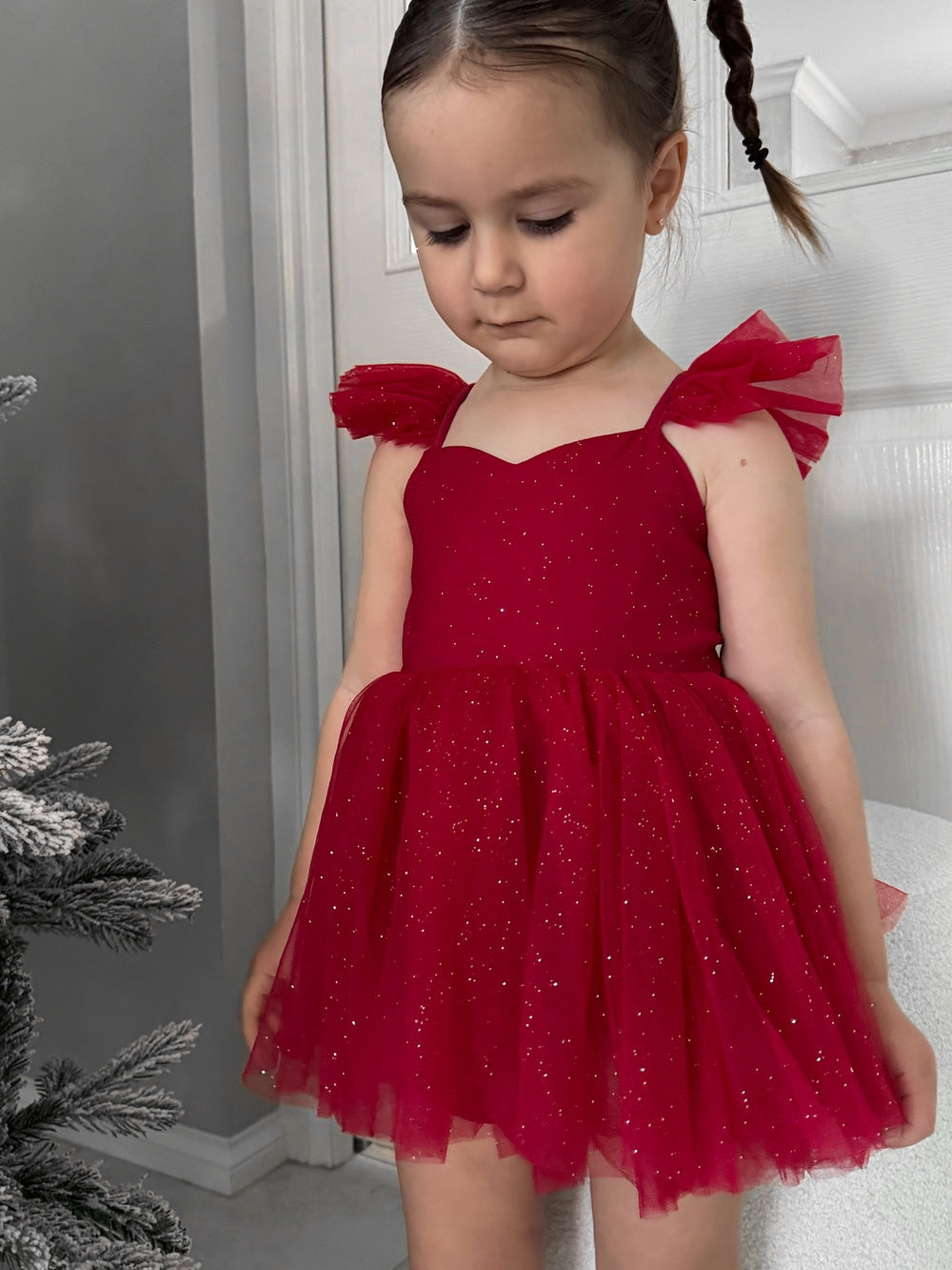 Shimmery red baby romper with puff skirt effect and sparkle detail