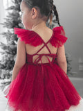 Red sparkle baby romper with adjustable back tie and glitter finish