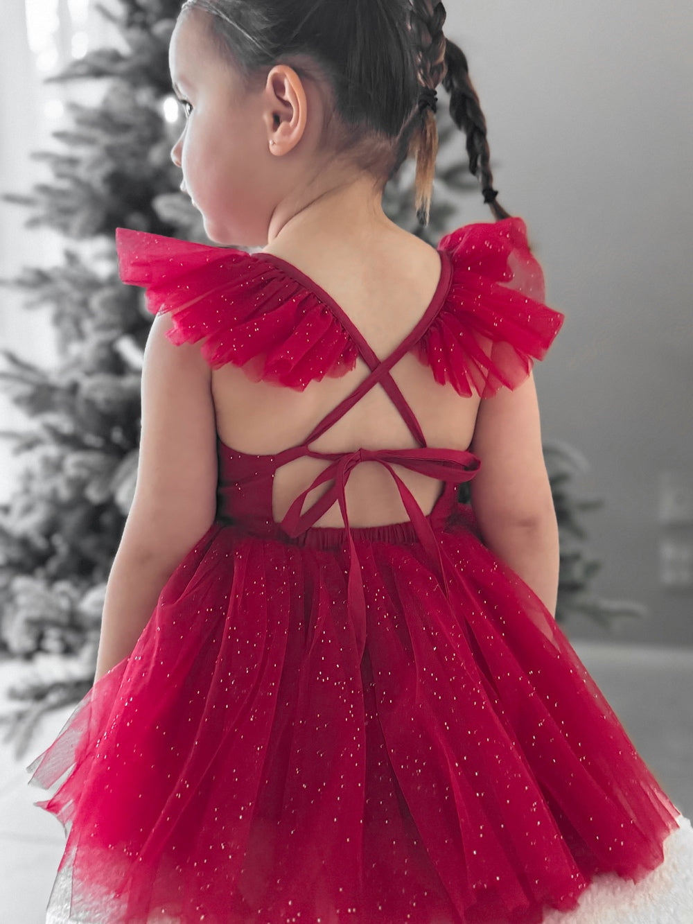 Red sparkle baby romper with adjustable back tie and glitter finish