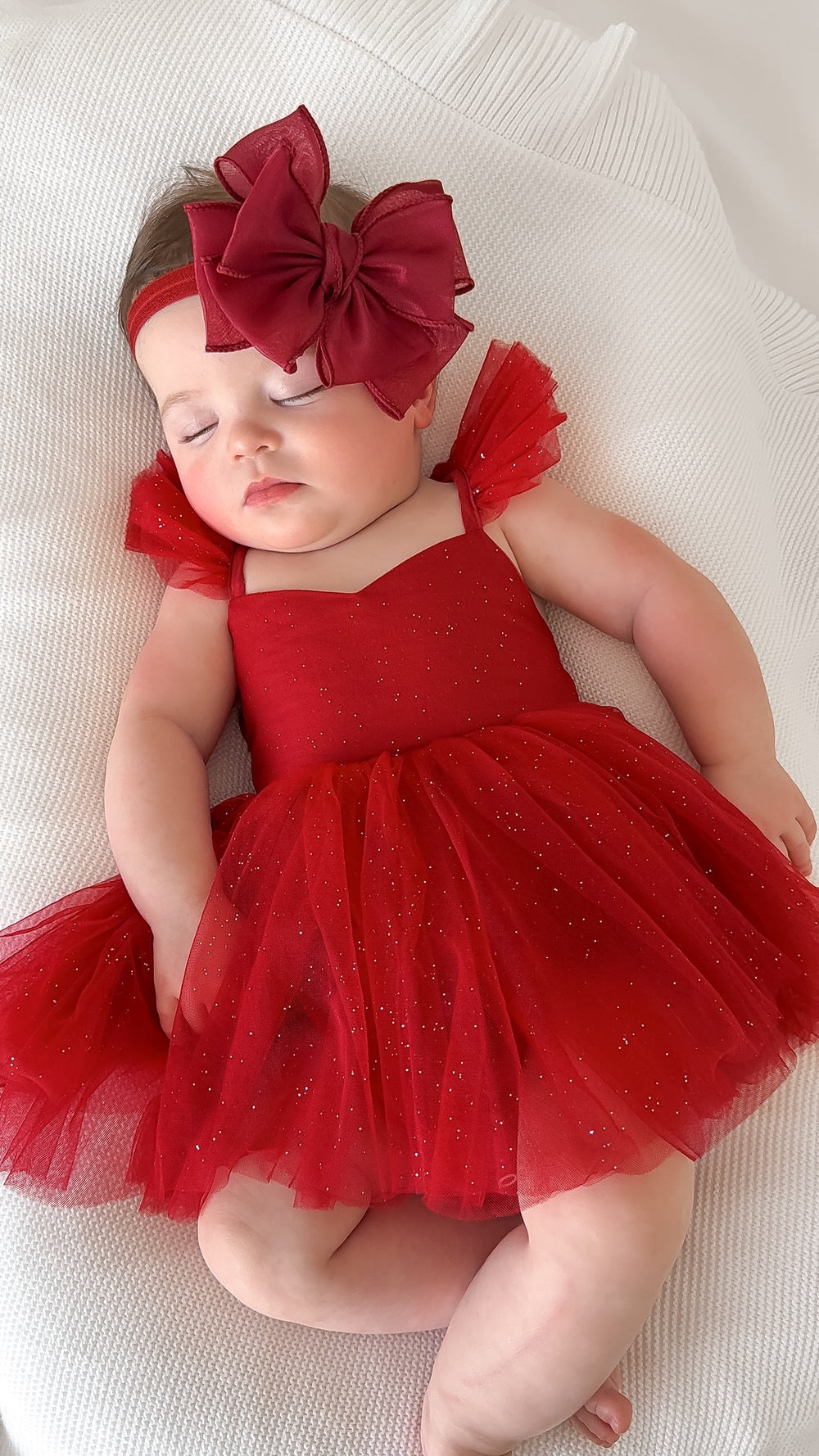 Front view of Belle red sparkle baby dress with cotton lining