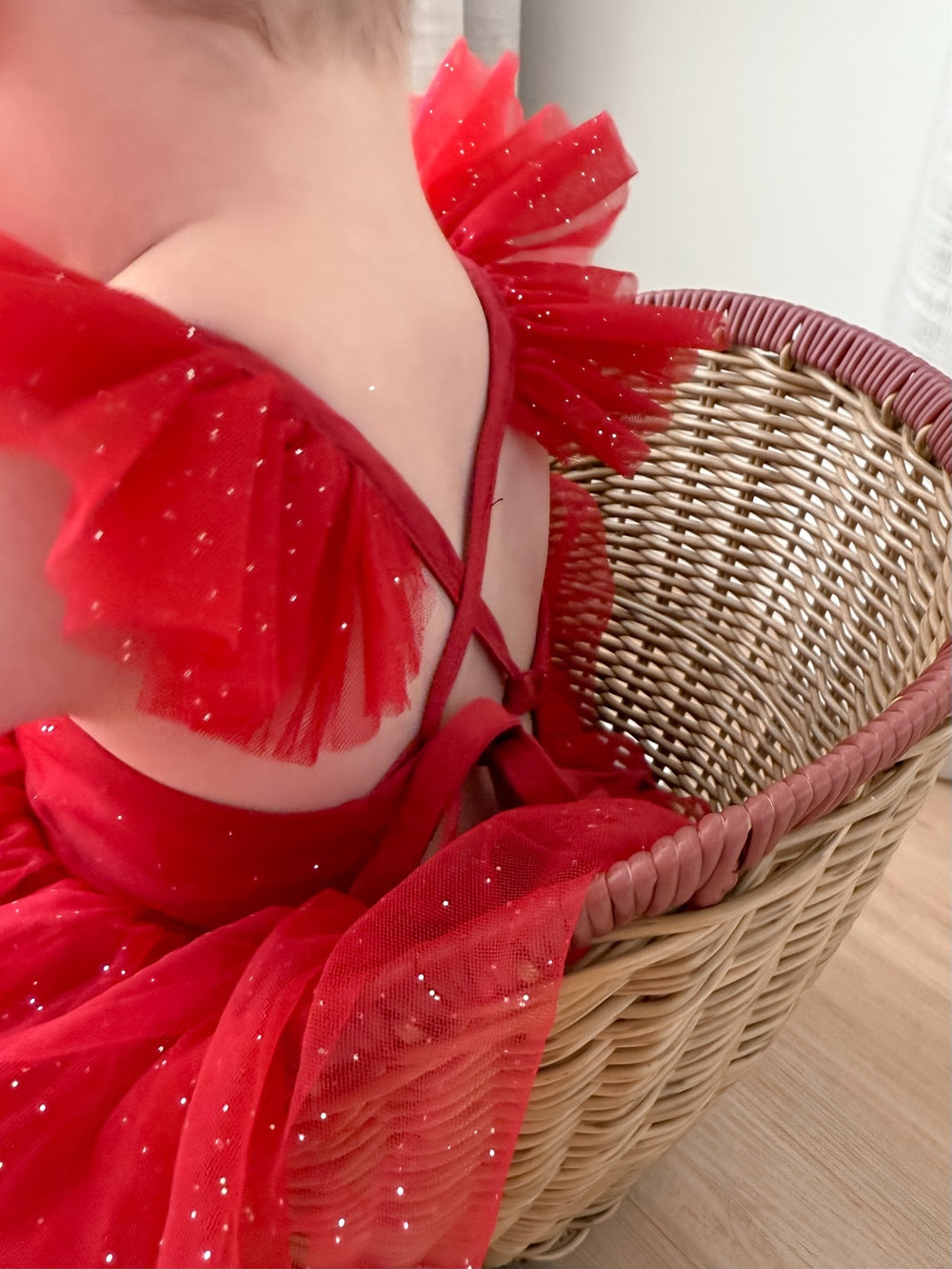 Back view of crossover straps and bow on red sparkle baby tutu