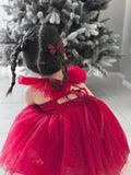 Girls’ holiday dress showing bow-tie back and shimmering tulle layers.