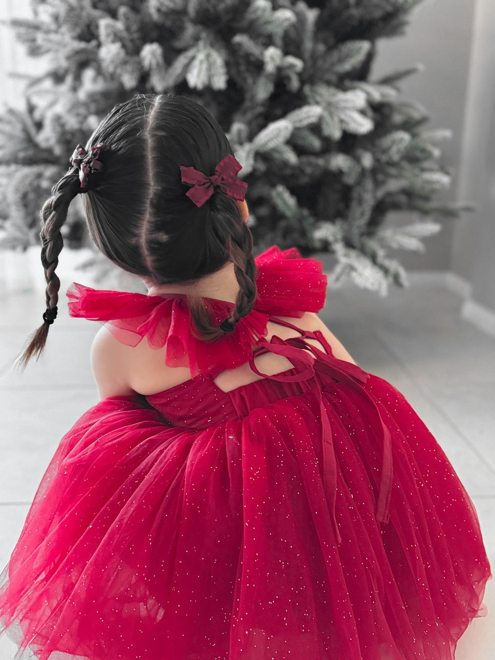 Girls’ holiday dress showing bow-tie back and shimmering tulle layers.