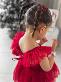 Red holiday dress in motion showing glittery tulle flutter sleeves.