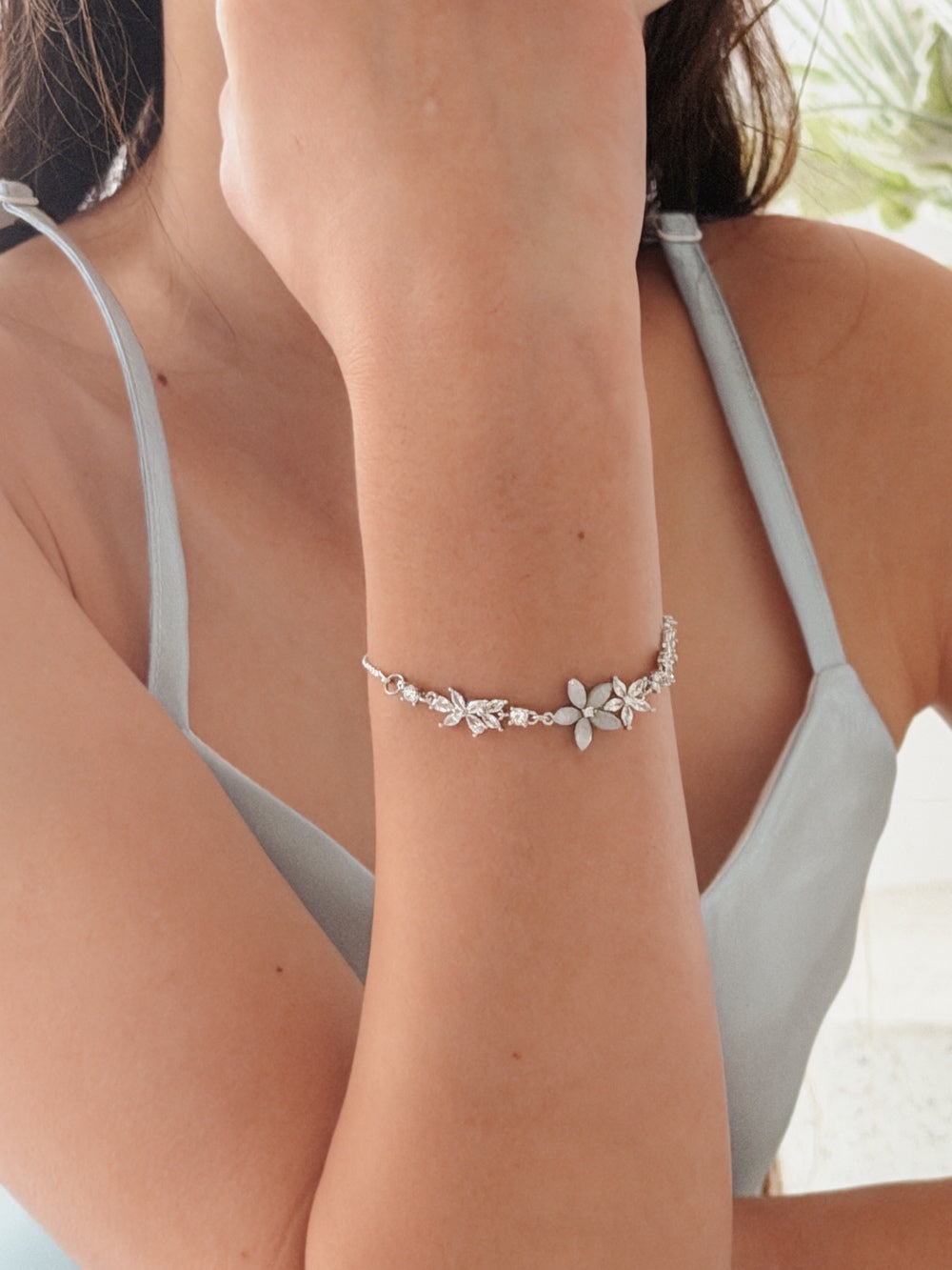 Blossom flower bracelet styled with white special occasion dress