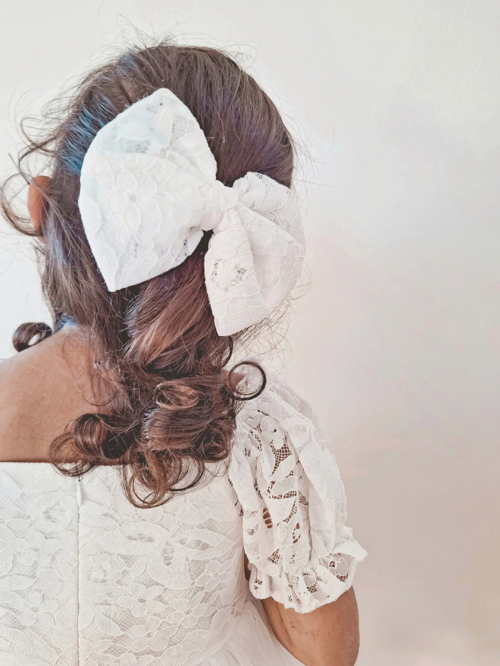 Callista White Bow - A Little Lacey · Photo 1 of 4