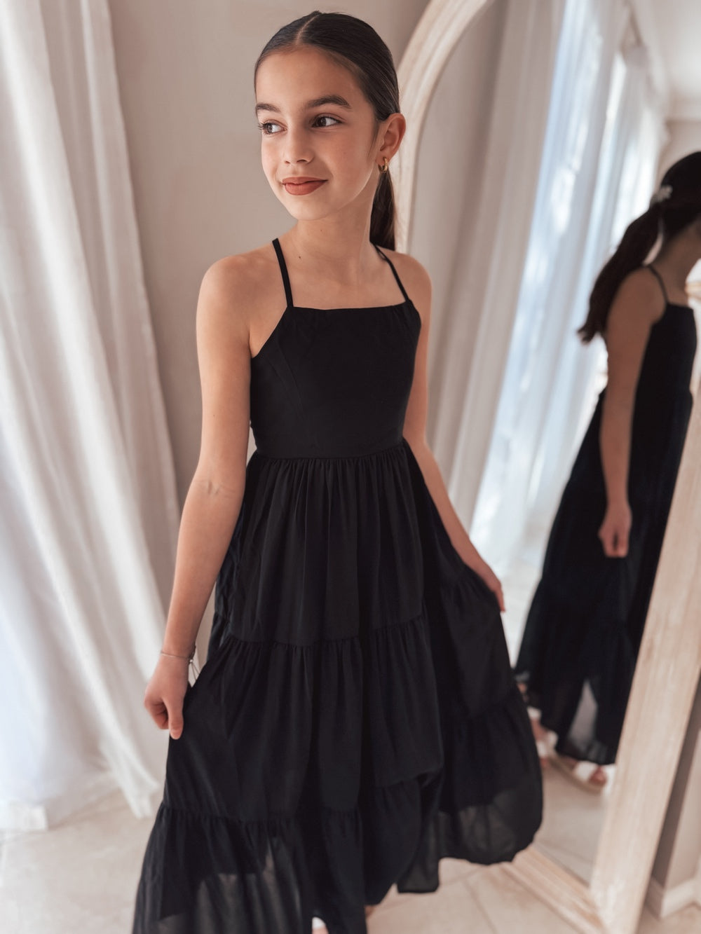 Special occasion dress in black with square neckline and flowing layers