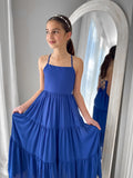 Clara dress in rich blue styled with flowing skirt and modern neckline