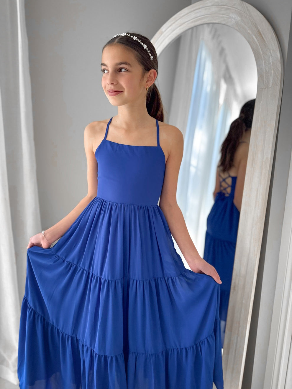 Clara dress in rich blue styled with flowing skirt and modern neckline