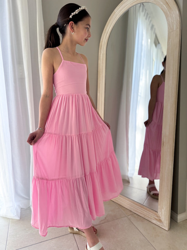 Movement shot of pink maxi dress styled for birthdays or special events