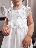 Close-up of pearl and tulle flower details on white flower girl dress